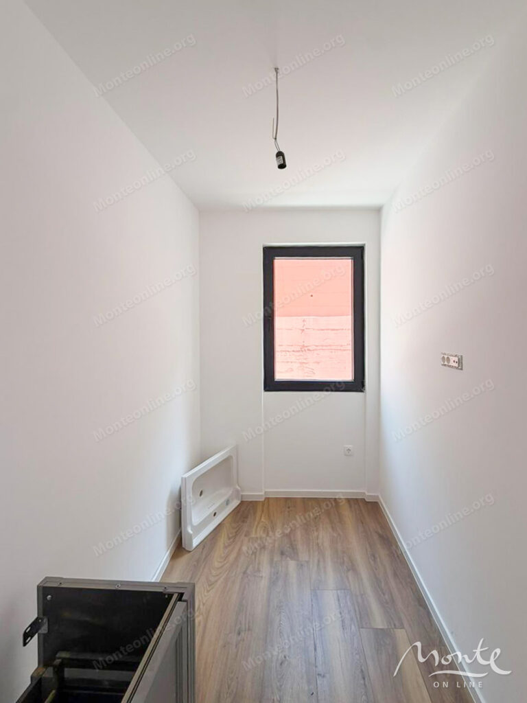 Two-bedroom apartment in a modern residential complex with a swimming pool in Budva 06
